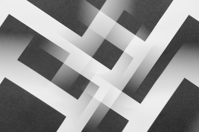 Minimalist abstract geometric pattern in black and white with layered designs.