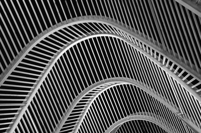 Futuristic black and white abstract architecture showcasing geometric patterns and curves.